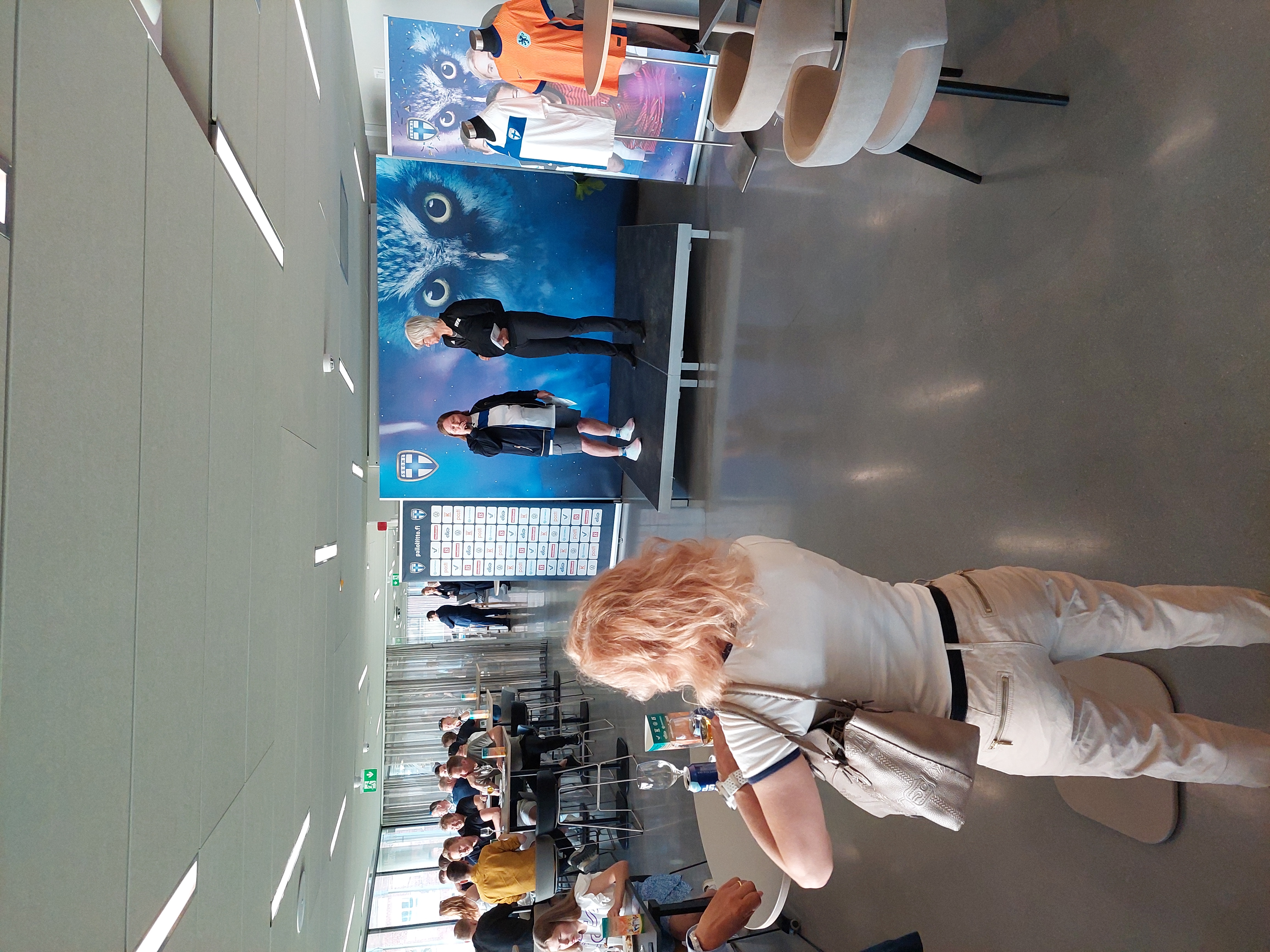 cafeteria,indoors,restaurant,handbag,person,shoe,chair,belt,people,table