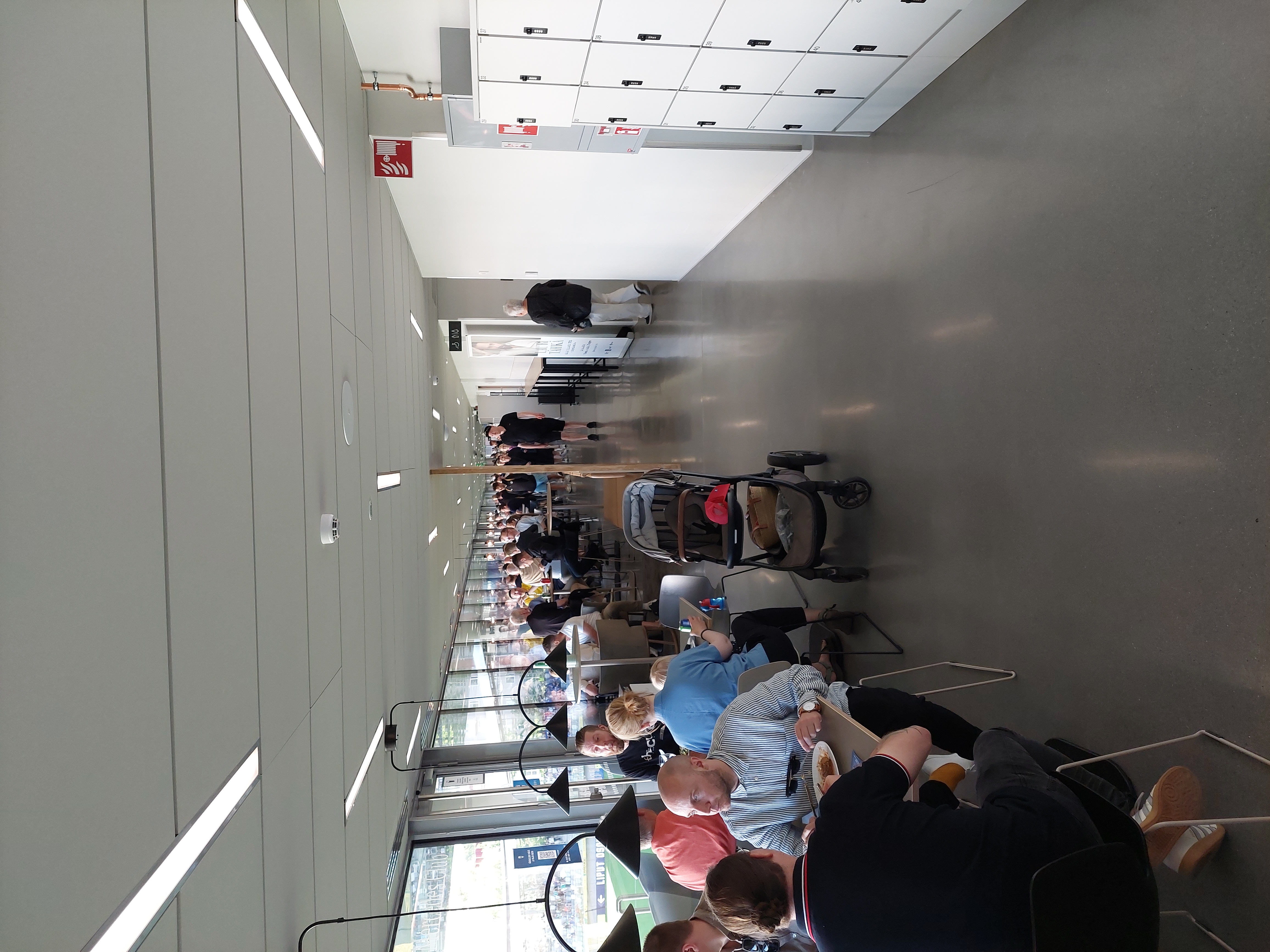 cafeteria,indoors,furniture,lounge,person,handbag,adult,male,man,plate