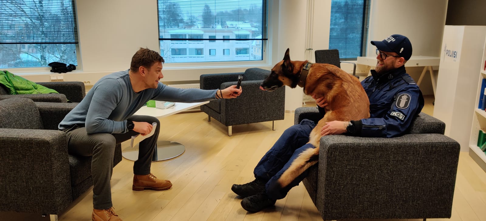 person,man,adult,male,furniture,conversation,canine,mammal,glasses,pet